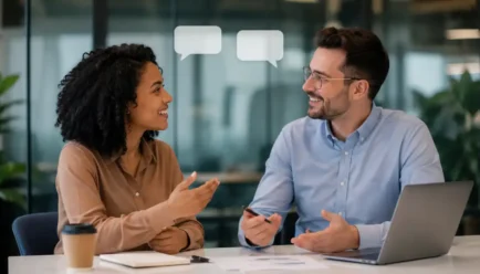 Two diverse professionals having a friendly office discussion and agreeing with each other, with subtle speech bubbles and a modern workspace in the background.