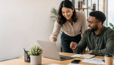Two diverse professionals collaborating on a project in a modern office, representing teamwork, positive impact, meaningful contribution, and effective communication.